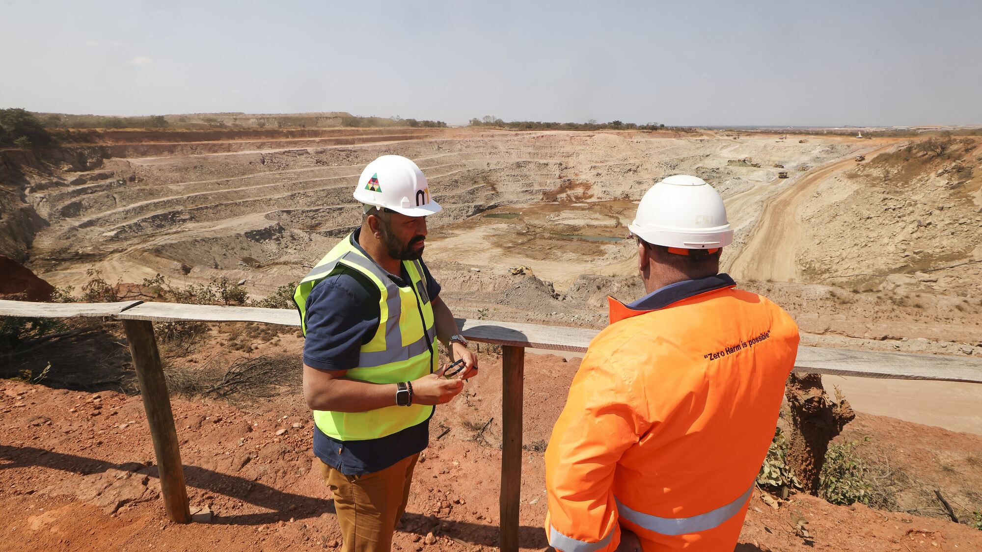Mine workers overlooking an open-pit copper mine on the Zambian Copperbelt